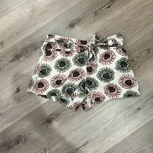 Cream, pink, rust, blue shorts with belt. Front and back pockets